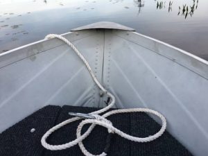 taken from inside a boat of the bow of the boat on the lake