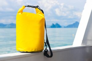 yellow waterproof bag for travel at the sea , protect